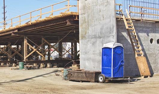 portable restrooms set up for workers’ use at a busy work site